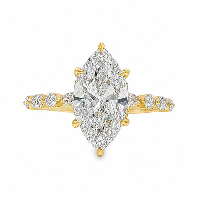 2.5 Ct marquise diamond engagement ring in yellow gold with accent diamonds on band.
