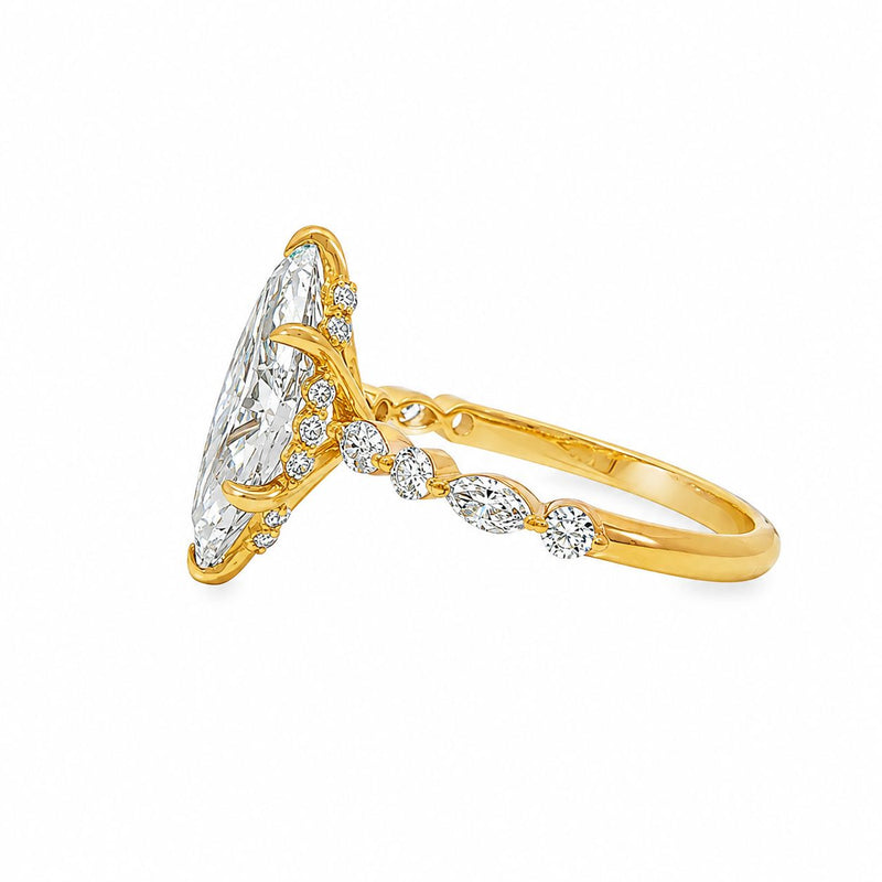 Gold engagement ring with 2.50 Ct marquise diamond and smaller round diamonds on band.