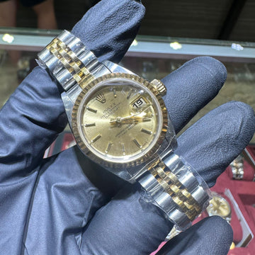 Rolex DateJust 26mm two-tone gold steel bracelet champagne stick dial date window.
