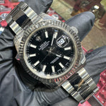 Rolex DateJust 41mm stainless steel watch with black stick dial and fluted bezel.