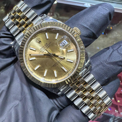 Rolex DateJust 41mm two-tone yellow gold watch with champagne stick dial and fluted bezel.