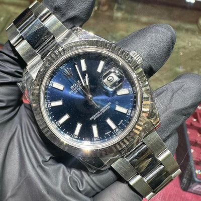 Rolex DateJust 41mm stainless steel watch with blue stick dial and fluted bezel.