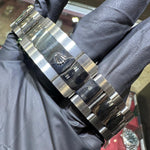 Rolex Oystersteel bracelet with polished center links and engraved Rolex crown clasp.
