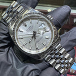 Rolex DateJust 36mm stainless steel watch with silver stick dial and Jubilee bracelet.