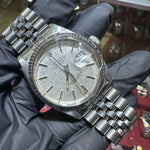 Rolex DateJust 36mm stainless steel watch with silver stick dial and jubilee bracelet.