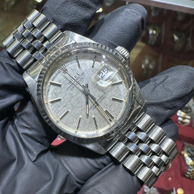 Rolex DateJust 36mm stainless steel watch with silver stick dial and jubilee bracelet.