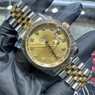 Rolex Datejust 36mm in two tone Oystersteel and 18K yellow gold with a champagne diamond dial and fluted bezel