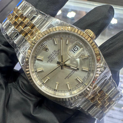 Rolex Datejust 36mm in two tone Oystersteel and 18K yellow gold with a silver stick dial and fluted bezel