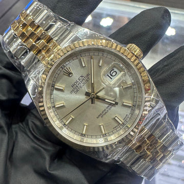 Rolex Datejust 36mm in two tone Oystersteel and 18K yellow gold with a silver stick dial and fluted bezel