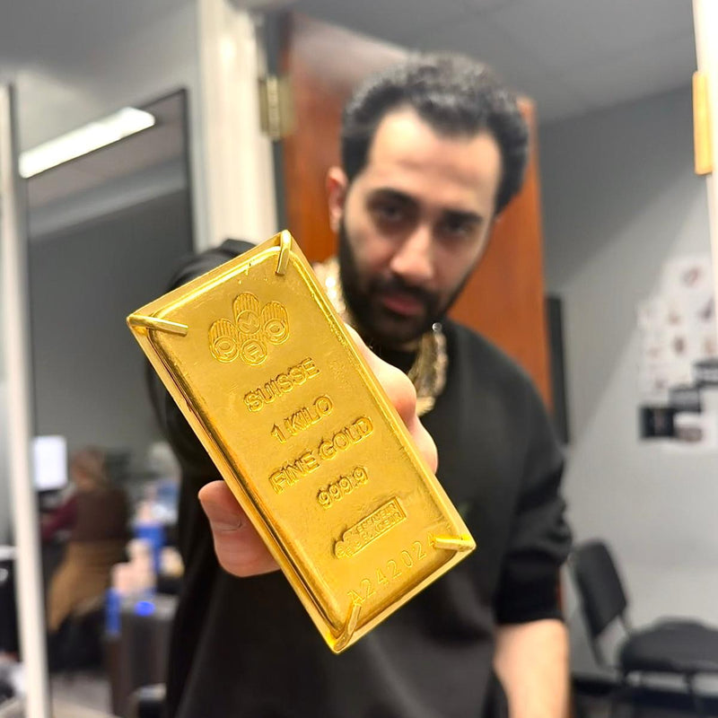 24k gold four-finger ring styled as a gold bullion bar with detailed engravings.