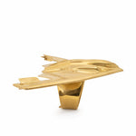 Polished gold four-finger ring shaped like a B-2 bomber airplane with smooth finish.