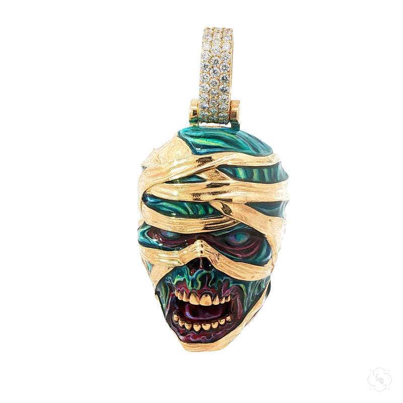 Yellow gold mummified zombie pendant with glow-in-the-dark enamel and diamond accents.