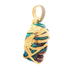 Gold pendant shaped like a zombie head wrapped in glow-in-the-dark green enamel bandages with diamond bail.