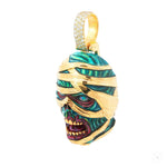 Yellow gold mummified zombie pendant with glow-in-the-dark enamel and diamond accents.