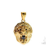 Yellow gold lion head pendant with black diamond eyes and detailed mane design.