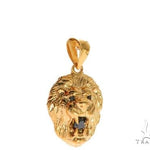 Yellow gold lion head pendant with black diamond eyes and detailed mane design.
