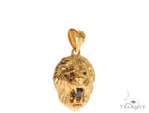 Yellow gold lion head pendant with black diamond eyes and detailed mane design.