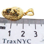 Yellow gold lion head pendant with black diamond eyes and detailed mane design.