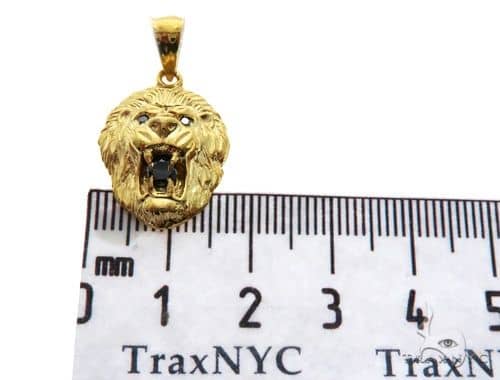 Yellow gold lion head pendant with black diamond eyes and detailed mane design.