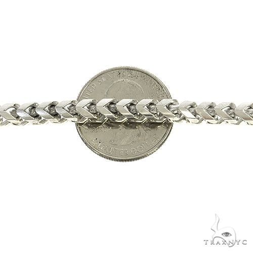 Close-up of a thick .925 silver chain link bracelet with a U.S. quarter for scale