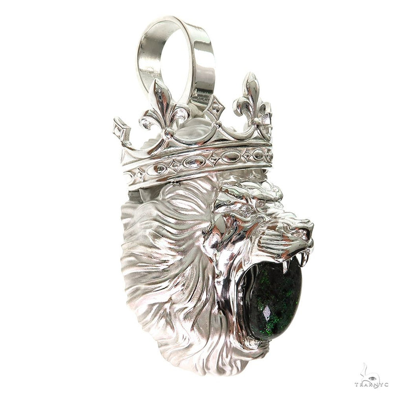 Sterling silver lion pendant with detailed mane and dark green gemstone in mouth