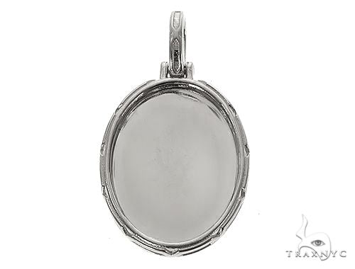 Oval .925 silver photo pendant with engraved frame and bail for chain attachment.