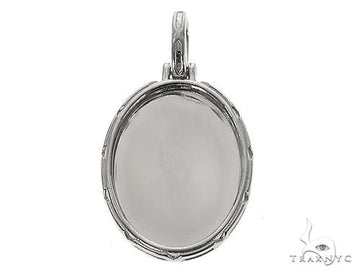 Oval .925 silver photo pendant with engraved frame and bail for chain attachment.