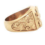 Yellow gold men's signet ring with intricate royal filigree floral design.