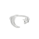 Sterling silver adjustable ring with crescent moon and small star detail.