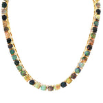 Gold chain necklace with round black opal gemstones evenly spaced around the links.
