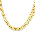 Gold chain necklace with round black opal gemstones evenly spaced around the links.
