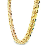 Gold chain necklace with round black opal gemstones evenly spaced around the links.