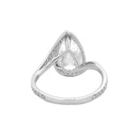 Pear-shaped diamond engagement ring with pavé diamond band in white gold.