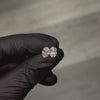 Pair of oval diamond stud earrings with cluster setting in white gold prong mount