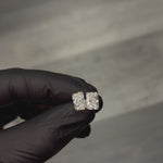Pair of radiant cut diamond stud earrings with four-prong white gold setting, brilliant facets
