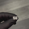 Pair of radiant cut diamond stud earrings with four-prong white gold setting, brilliant facets
