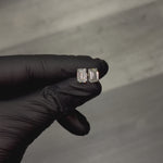 Pair of emerald cut diamond stud earrings with four-prong white gold setting