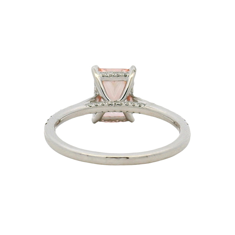 White gold engagement ring with rectangular pink diamond and small diamonds on band.