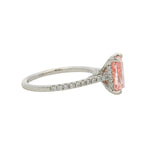 White gold engagement ring with rectangular pink diamond and small diamonds on band.