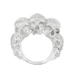 Silver skull ring with three detailed skulls and a matte finish, bold men’s jewelry design.