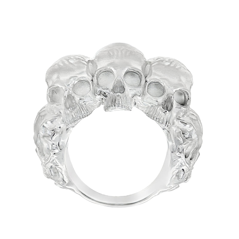 Silver skull ring with three detailed skulls and a matte finish, bold men’s jewelry design.