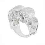 Silver skull ring with three detailed skulls and a matte finish, bold men’s jewelry design.