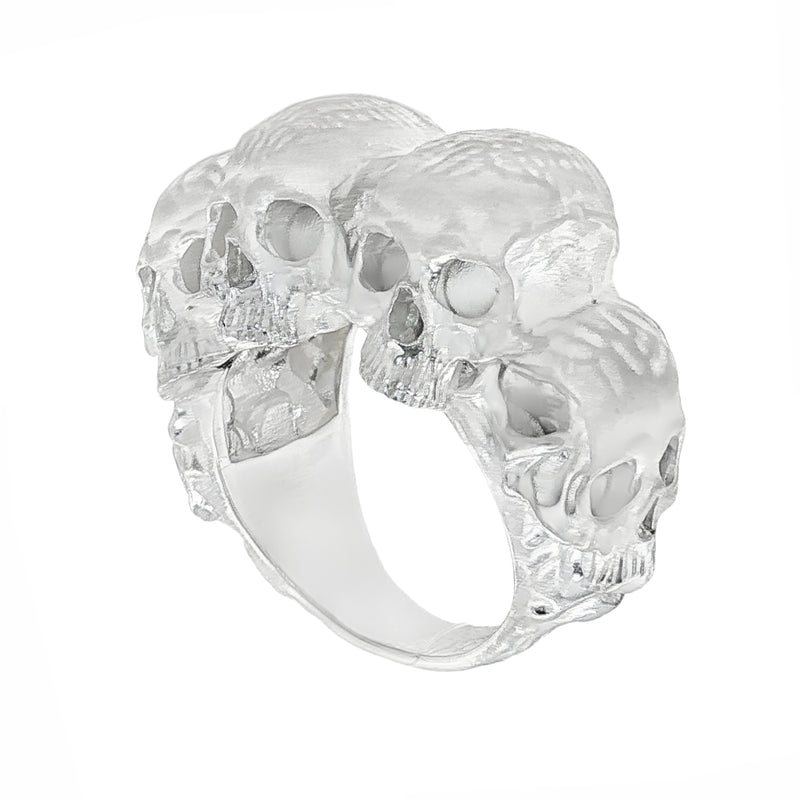 Silver skull ring with three detailed skulls and a matte finish, bold men’s jewelry design.