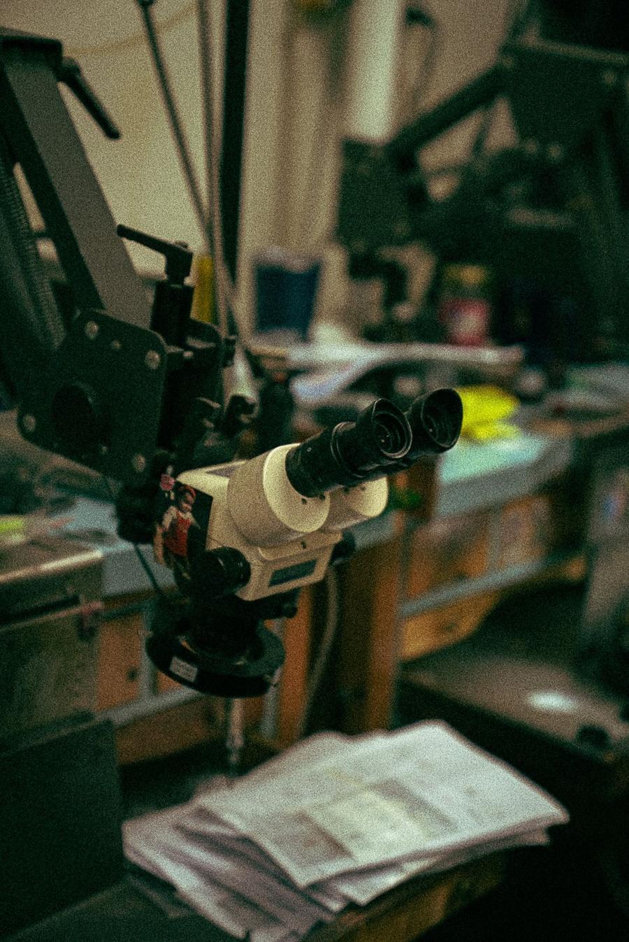 A bench microscope over the workshop tables